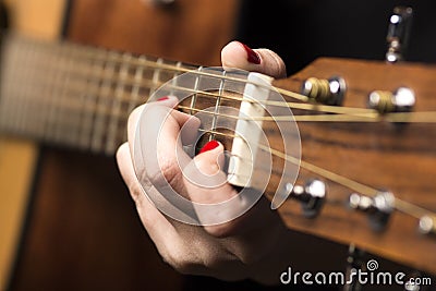 Young woman clamped with fingers guitar strings Stock Photo