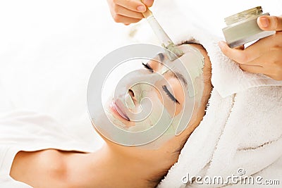 Young woman with clay facial mask Stock Photo