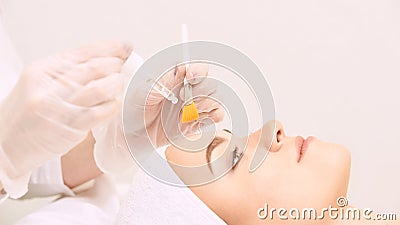 Young woman cleaning face skin in salon. Retinol peel with brush. Acid organic peeling Stock Photo