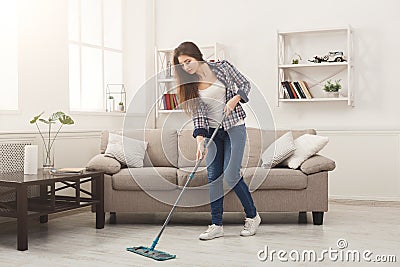 Young woman cleaning house with mop Stock Photo