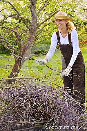 Young woman cleaning tree limbs Stock Photo