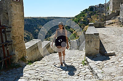 Young woman climbing a flight of steps in the old town of Matera, UNESCO World Heritage Site and European Capital of Culture 2019. Stock Photo