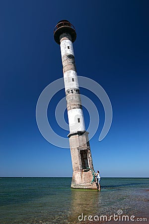 Young woman climbing into lighthouse. Stock Photo