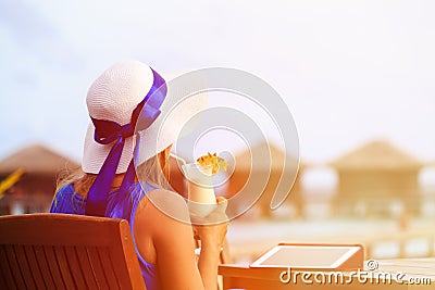 Young woman with cocktail and touch pad at luxury Stock Photo