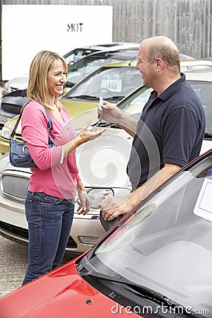 Young woman collecting new car Stock Photo