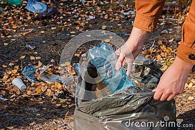 Young woman collects garbage Stock Photo