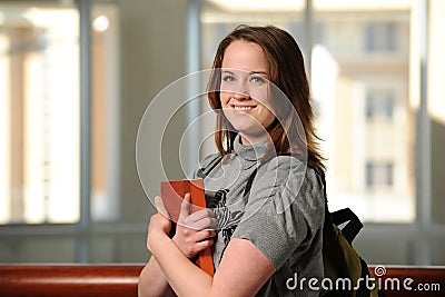 Young Woman College Student holding a book Stock Photo