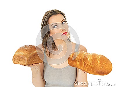 Young Woman Comparing White and Brown Bread Stock Photo