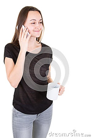 Young woman connected using smart mobile phone taking hot drink in mug in white background Stock Photo