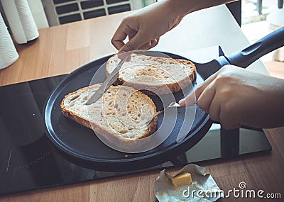 Young woman cooking bread breakfast on counter bar kitchen Stock Photo