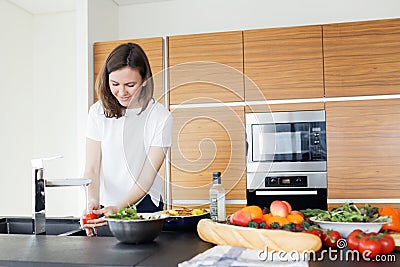 Young woman cooking healthy food in the kitchen Stock Photo