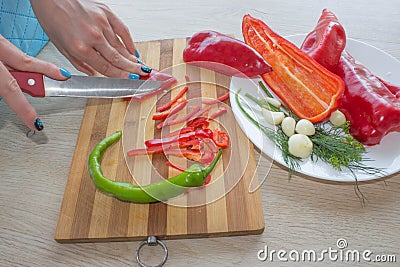 Young woman cooking healthy meal in the kitchen. Cooking healthy food at home Stock Photo