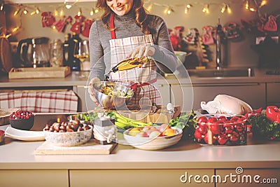 Young Woman Cooking in the kitchen. Healthy Food for Christmas stuffed duck or Goose Stock Photo