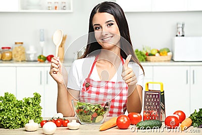 young woman cooking salad Stock Photo