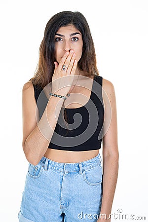 Young woman cover mouth with hands with shocked surprised expression to keep secret or saying oops on white background Stock Photo