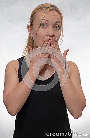 Young woman covering mouth with her hands Stock Photo