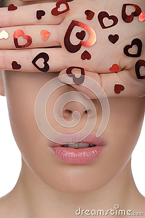 Young woman covers his eyes with hand hearts Stock Photo