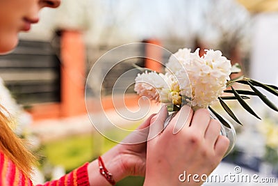 Young woman creating a small hyacinth bouquet Stock Photo