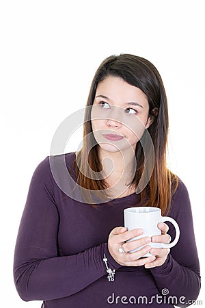 Young woman with cup mug of coffee looks up make funny face Stock Photo