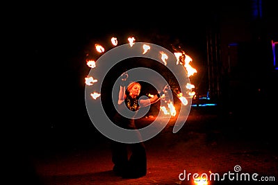 Young woman dancing dance with fire fan in her hand Editorial Stock Photo