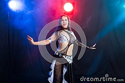 Young woman dancing in Tribal Fusion style. Belly dance on the stage. Stock Photo