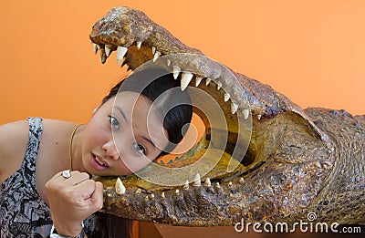 Young woman in danger with crocodile mouth Stock Photo