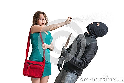 Young woman is defending with pepper spray against armed thief with knife. Stock Photo