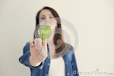 Young woman designer touching virtual button start. New start, beginning, business concept Stock Photo