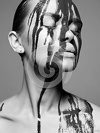 Young woman with Dirty Face. Girl in Paint Stock Photo