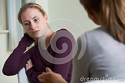Young Woman Discussing Problems With Counselor Stock Photo