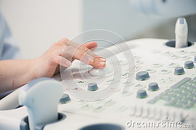 Young woman doctor`s hands close up preparing for an ultrasound device scan. Stock Photo