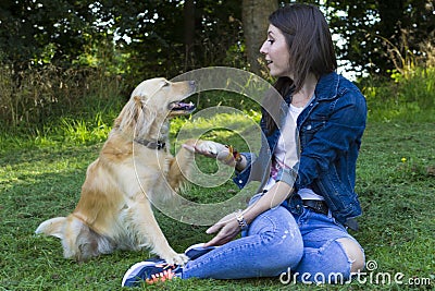 Young woman and dog in forest Stock Photo