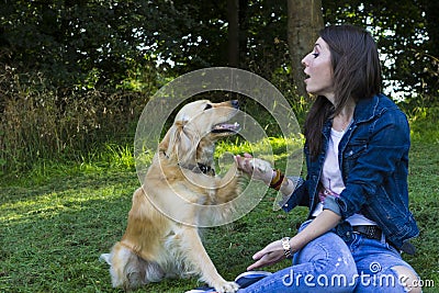 Young woman and dog in forest Stock Photo