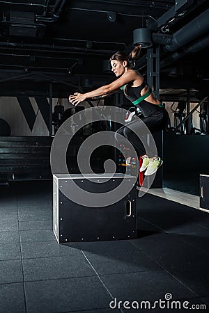 Young woman doing a box jump exercise. Stock Photo