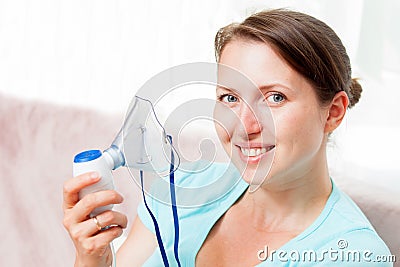 Young woman doing inhalation with a nebulizer at home Stock Photo