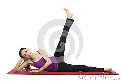 Young woman doing leg raising during workout Stock Photo