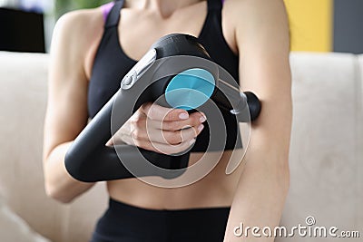 Young woman doing massage relaxing massage for hands in vibrating massager Stock Photo