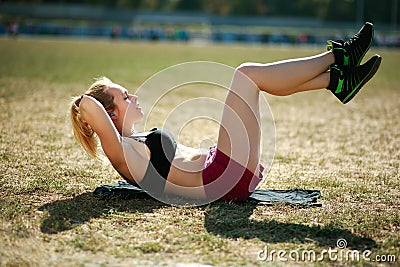 Young woman doing press fitness exercise for stomach muscles Stock Photo