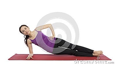 Young woman doing a variation of side plank pose Stock Photo