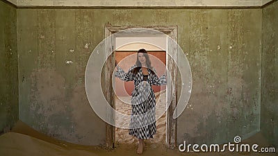 Young woman in dress and underwear in abandoned building posing in room. Stock Photo