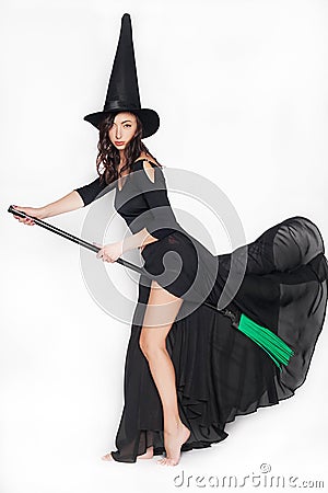 Young woman dressed as a witch on Halloween on an isolated background Stock Photo