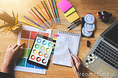 Young woman dressmaker or designer working choose color bar in t Stock Photo