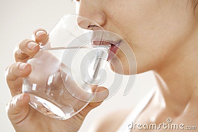 Young woman drinking glass of water Stock Photo