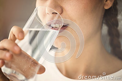 Young woman drinking glass of water close up view Stock Photo