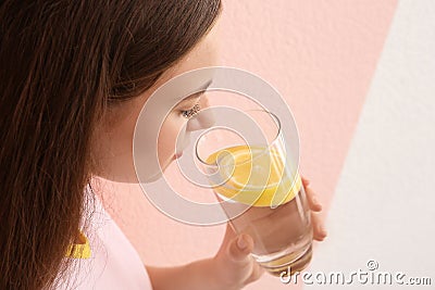 Young woman drinking lemon water Stock Photo