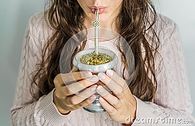 Young woman drinking traditional Argentinian yerba mate tea. Stock Photo