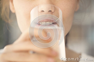 Young woman drinking water close up view Stock Photo