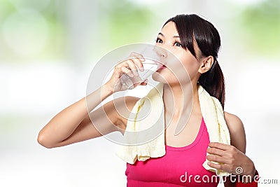 Young woman drinking water after sporting Stock Photo