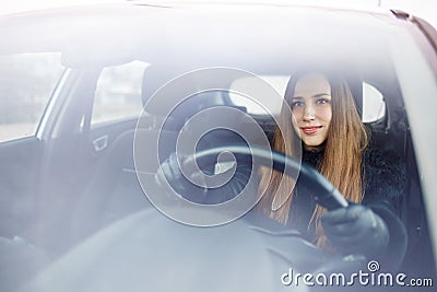 Young woman drive a car in winter Stock Photo