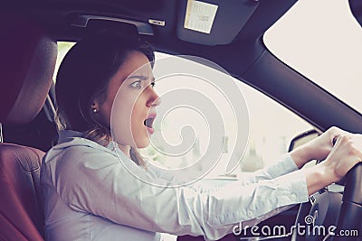 Young woman driving a car shocked about to have traffic accident Stock Photo